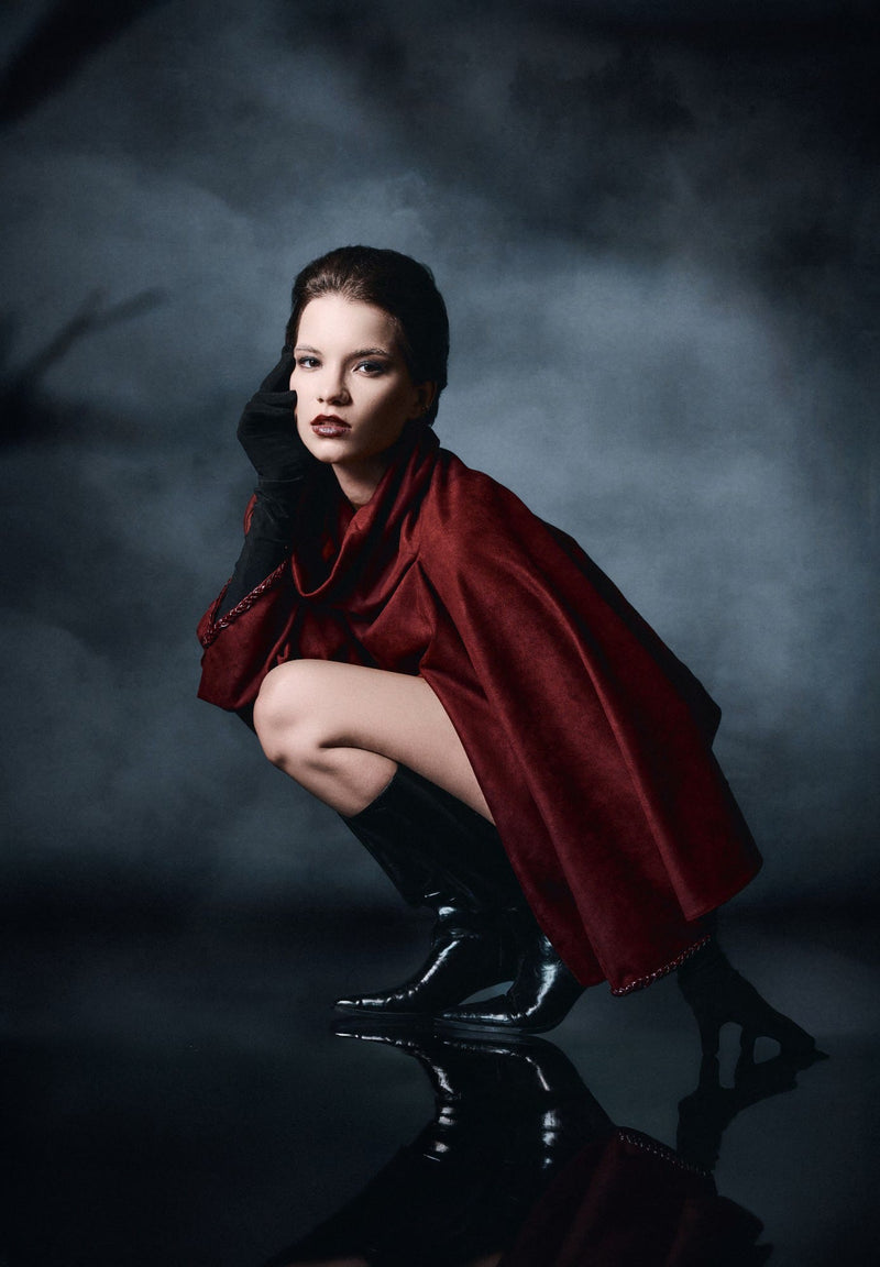 Noctra FW 26/27, oxblood cape on a reflective floor